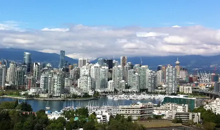 Vancouver skyline over the False Creek marina, with the North Shore mountains behind
